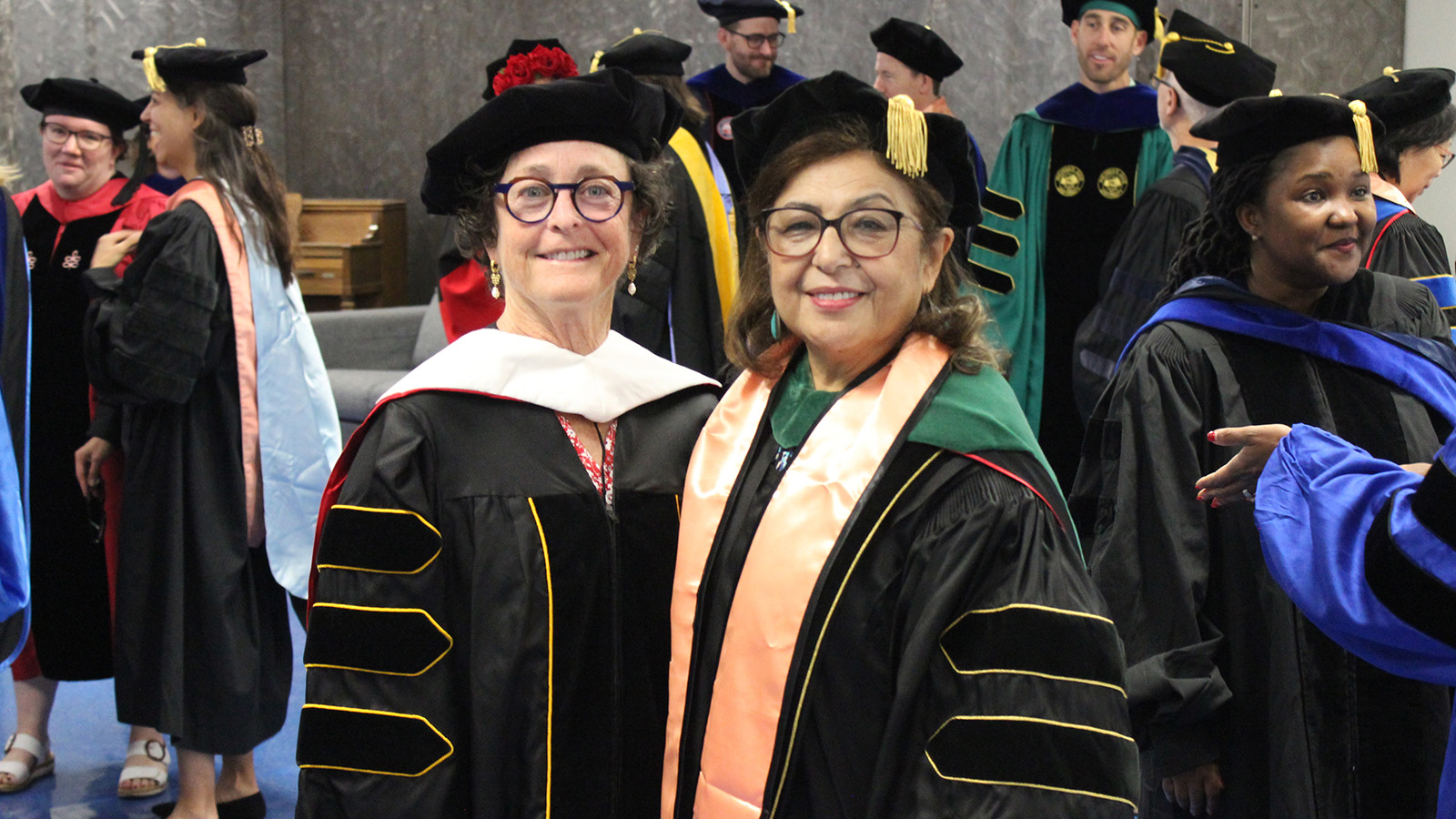 Amy Zuckerman with Dean Hakim, receiving an Honorary degree from the College
