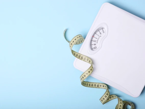 scale and measuring tape on floor