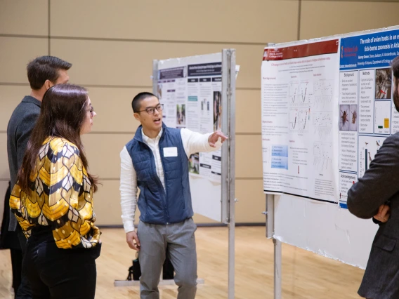 Public Health graduate student sharing his Poster Presentation