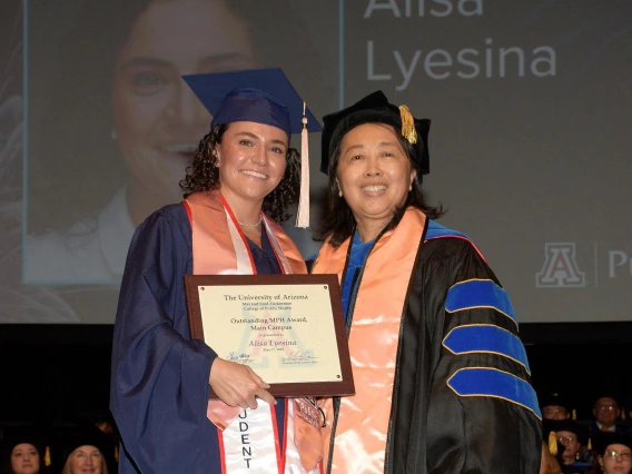 MPH graduate Alisa Lyesina receiving her student award from Dr. Chen