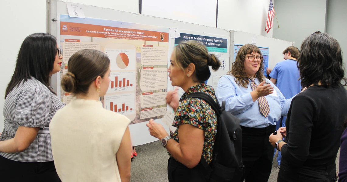 Students share their posters with viewers at the 2025 Public Health Poster Forum