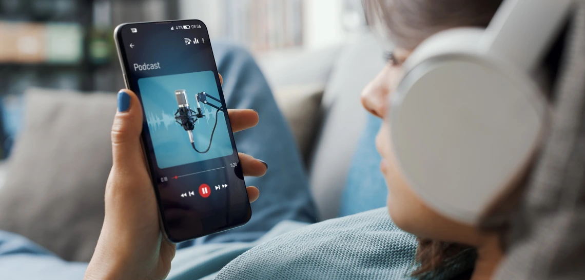 Woman listening to podcast on iPhone