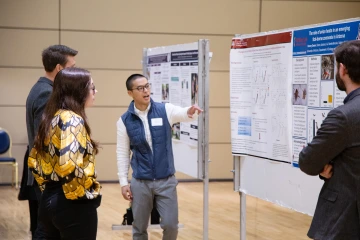 Public Health graduate student sharing his Poster Presentation