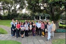 Dean Hamkim and Dr. Valdez with a large group of conference members, outdoors in a park