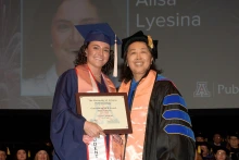 MPH graduate Alisa Lyesina receiving her student award from Dr. Chen