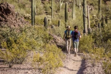 Two hikers on a desert trail