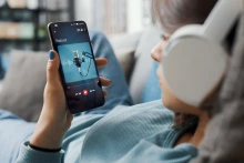 Woman listening to podcast on iPhone