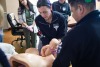 nurse practicing delivering baby with mannequin 