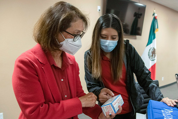 Drs. Rosales and Soto preparing COVID vaccines