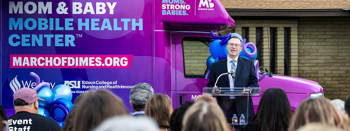 Assistant Dean Craig Laser speaks at the new Mom and Baby Mobile Health Center launch. Photo by Charlie Leight/ASU News
