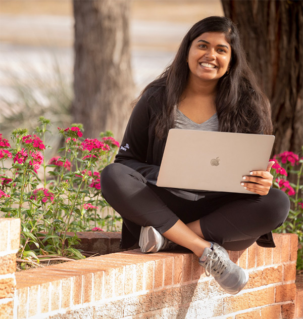 Student with laptop outside