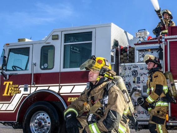 tucson firefighters in front of a fire truck